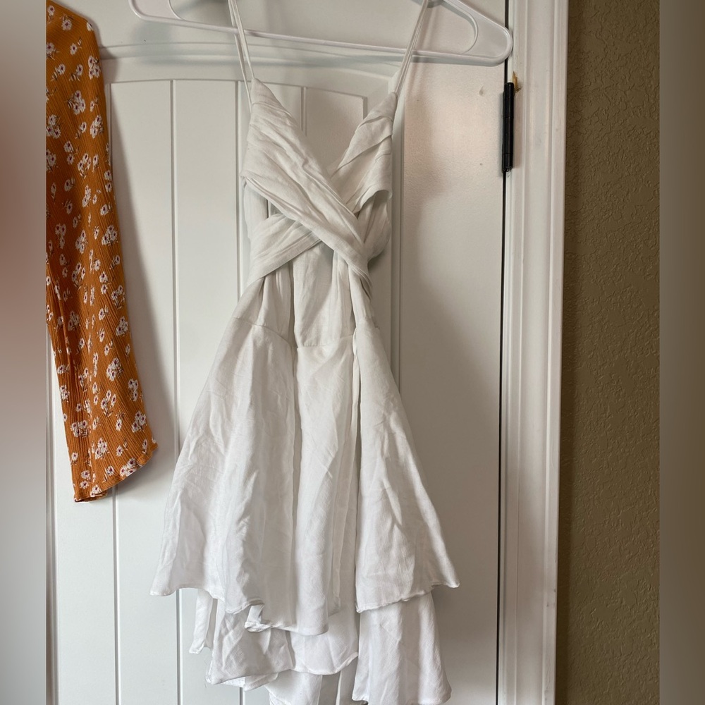 Purchased at Blu Spero, white romper with tie in the back bow. - Picture 2 of 3